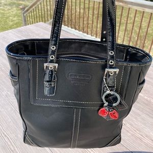 Coach black tote with ladybug keychain.